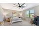 Comfortable bedroom featuring neutral colors, a ceiling fan, and natural light from the window at 18117 Gawthrop Dr # 103, Bradenton, FL 34211