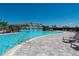 Stunning pool area featuring a rock waterfall and tiled deck with lounge chairs at 18117 Gawthrop Dr # 103, Bradenton, FL 34211