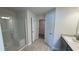 Contemporary bathroom showcasing a glass-enclosed shower, a single sink vanity, and access to the walk-in closet at 3884 S Haberland Blvd, North Port, FL 34288