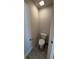 Clean and simple powder room with a toilet, gray wood-look tile flooring, and a towel rack at 3884 S Haberland Blvd, North Port, FL 34288