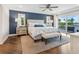 Main bedroom with water views, plush bedding, and a seating area at 5727 Riegels Point Rd, Sarasota, FL 34242