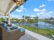 Relaxing waterfront deck with wicker furniture, overlooking the canal at 5727 Riegels Point Rd, Sarasota, FL 34242