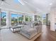 Bright and airy living room with a sectional sofa and access to a balcony at 5727 Riegels Point Rd, Sarasota, FL 34242