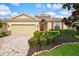 One-story home with landscaped yard and red door at 8214 Las Lilias Ct, Sarasota, FL 34243