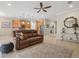 Spacious living room featuring a brown leather reclining sofa and a large flat-screen TV at 8214 Las Lilias Ct, Sarasota, FL 34243
