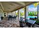 Community poolside patio with tables and chairs at 8214 Las Lilias Ct, Sarasota, FL 34243