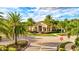 Community clubhouse with palm trees and landscaping at 8214 Las Lilias Ct, Sarasota, FL 34243