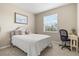 Bright bedroom with a queen-size bed, workspace, and window at 8214 Las Lilias Ct, Sarasota, FL 34243