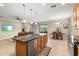 Open concept kitchen with island, granite countertops, and stainless steel appliances at 8214 Las Lilias Ct, Sarasota, FL 34243