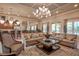 Spacious clubhouse living room with comfortable seating and large windows at 8214 Las Lilias Ct, Sarasota, FL 34243