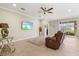Living area with a brown leather sofa and sliding glass doors to patio at 8214 Las Lilias Ct, Sarasota, FL 34243