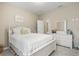 Charming bedroom with a white bed frame and dresser at 8214 Las Lilias Ct, Sarasota, FL 34243