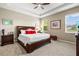 Large main bedroom with king-size bed and ceiling fan at 8214 Las Lilias Ct, Sarasota, FL 34243