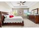 King-size bed in a well-lit main bedroom with a dresser at 8214 Las Lilias Ct, Sarasota, FL 34243
