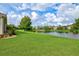 Spacious backyard with lush lawn and pond view at 8214 Las Lilias Ct, Sarasota, FL 34243