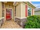 Front entrance with red door and stone accents at 8214 Las Lilias Ct, Sarasota, FL 34243