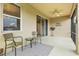 Peaceful screened porch with wicker chairs and a rug at 8214 Las Lilias Ct, Sarasota, FL 34243