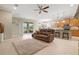 Open living area with leather sofa and kitchen at 8214 Las Lilias Ct, Sarasota, FL 34243