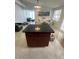 Kitchen island with granite countertop and dark wood cabinetry at 1928 9Th St, Sarasota, FL 34236