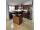 Modern kitchen with dark wood cabinets, granite island, and stainless steel appliances at 1928 9Th St, Sarasota, FL 34236