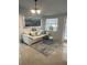 Living room with white couch, coffee table, and large ocean-themed artwork at 1928 9Th St, Sarasota, FL 34236