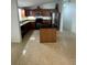 Modern kitchen with dark wood cabinets, granite island, and stainless steel appliances at 1928 9Th St, Sarasota, FL 34236
