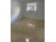 Spacious bedroom with terrazzo flooring and a large window at 1928 9Th St, Sarasota, FL 34236