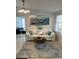 Bright living room with white couch, coffee table, and ocean-themed artwork at 1928 9Th St, Sarasota, FL 34236