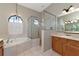 Bathroom with double vanity, soaking tub, and separate shower at 259 Dahlia Ct, Bradenton, FL 34212