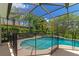 Refreshing screened pool with safety fence and tropical plants at 259 Dahlia Ct, Bradenton, FL 34212