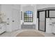 Spa-like bathroom with soaking tub, walk-in shower, and large window at 158 Allworthy St, Port Charlotte, FL 33954