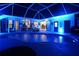 Night view of a pool and patio with blue lighting at 158 Allworthy St, Port Charlotte, FL 33954