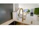 Close-up of a kitchen sink with gold faucet and modern countertop at 18770 Mcgrath Cir, Port Charlotte, FL 33948
