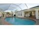 Inviting screened-in pool with brick pavers and comfortable seating at 18770 Mcgrath Cir, Port Charlotte, FL 33948