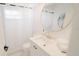Modern bathroom with white vanity, gold fixtures, and a large round mirror at 18770 Mcgrath Cir, Port Charlotte, FL 33948