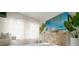 Bright living room featuring large windows, a comfortable sofa, and stylish decor at 18770 Mcgrath Cir, Port Charlotte, FL 33948