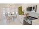 Kitchen features white cabinets, quartz countertops and breakfast nook at 18770 Mcgrath Cir, Port Charlotte, FL 33948