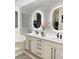Double vanity bathroom with hexagon tile and modern lighting at 11061 Sandrift Ave, Englewood, FL 34224