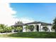 Modern home with two-car garage and manicured lawn at 11061 Sandrift Ave, Englewood, FL 34224