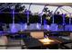 Relaxing fire pit area next to the pool at night at 11061 Sandrift Ave, Englewood, FL 34224