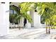 Bright and airy front porch with white adirondack chairs and white rock landscaping at 11061 Sandrift Ave, Englewood, FL 34224