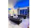 Elegant living room with blue accent lighting and plush sofas at 11061 Sandrift Ave, Englewood, FL 34224