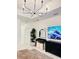 Modern bedroom featuring a large TV and stylish dresser at 11061 Sandrift Ave, Englewood, FL 34224