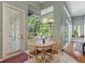 Dining area with wood table and chairs and windows overlooking the screened lanai at 1206 86Th Nw Ct, Bradenton, FL 34209