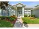 Front yard of a home with a walkway, green grass, and some shrubs at 1206 86Th Nw Ct, Bradenton, FL 34209