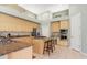 Spacious kitchen with ample wood cabinetry, an island with bar seating, and stainless steel appliances at 1206 86Th Nw Ct, Bradenton, FL 34209