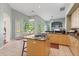 Spacious kitchen with an island, light wood cabinetry, and ample natural light at 1206 86Th Nw Ct, Bradenton, FL 34209