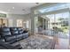 The living room features wood floors, sliding glass doors to the patio, and views of the pool area at 1206 86Th Nw Ct, Bradenton, FL 34209