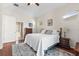 Large main bedroom with hardwood floors, ceiling fan, ensuite bathroom, and plenty of natural light at 1206 86Th Nw Ct, Bradenton, FL 34209