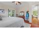 This main bedroom offers hardwood floors, a view of the pool, and an attached sitting area at 1206 86Th Nw Ct, Bradenton, FL 34209